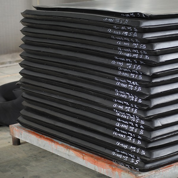 Large inventory of raw neoprene sponge slabs stacked on pallets at UooSport warehouse ready for splitting